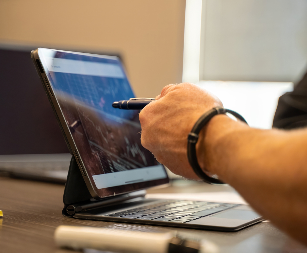 Financial Products financial advisor pointing to a chart on a tablet